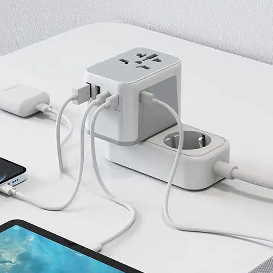 Universal travel power adapter charging a phone and tablet via multiple USB cables